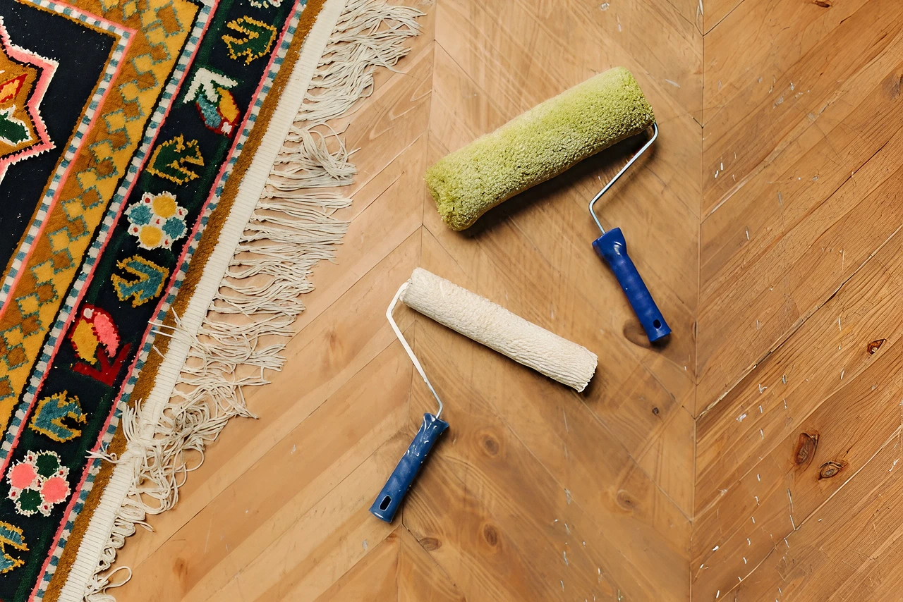 Carpet repair and cleaning tools lying beside a carpet