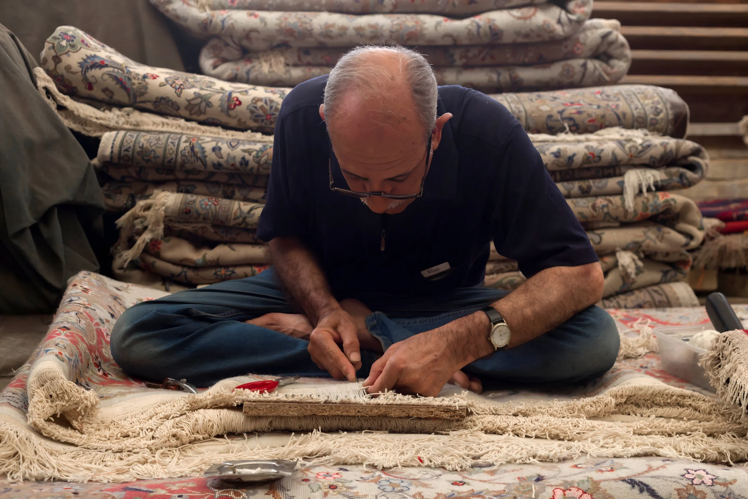man-performing-carpet-repair A man engaged in carpet repair